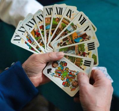 ręka gracza z rozłożonymi w wachlarz kartami do taroków